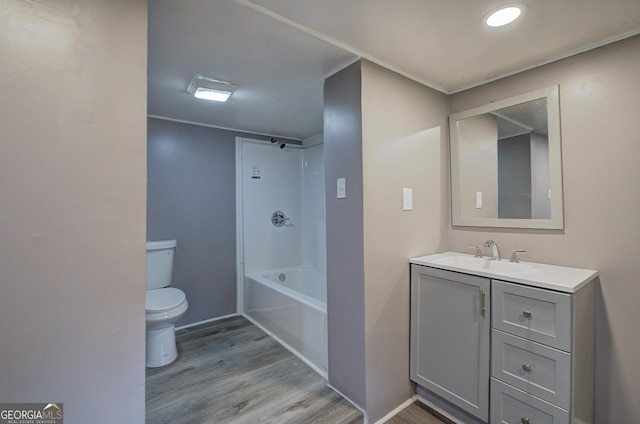 full bathroom featuring vanity, toilet,  shower combination, and hardwood / wood-style flooring