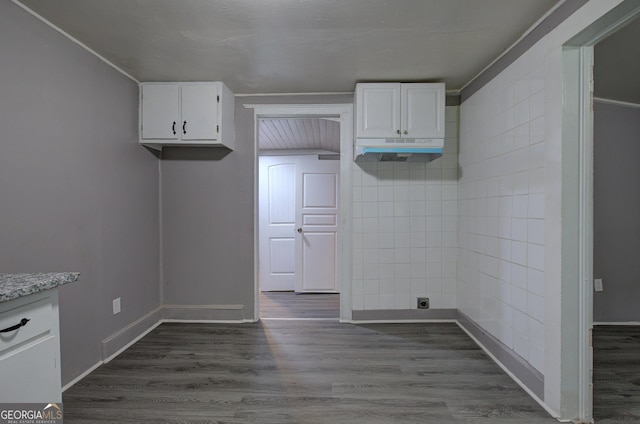 kitchen with white cabinets, crown molding, and hardwood / wood-style floors