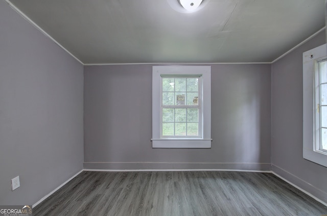 spare room with wood-type flooring and ornamental molding