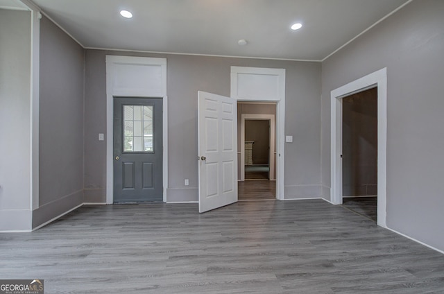 entryway featuring crown molding and wood-type flooring