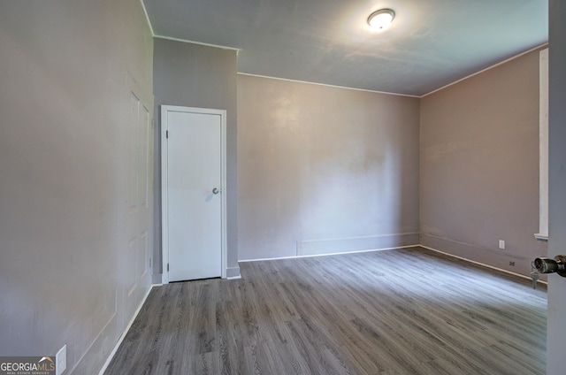 unfurnished room with hardwood / wood-style floors