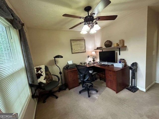 carpeted office featuring baseboards and a textured ceiling