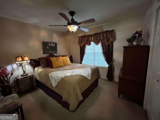 bedroom with light carpet and a ceiling fan