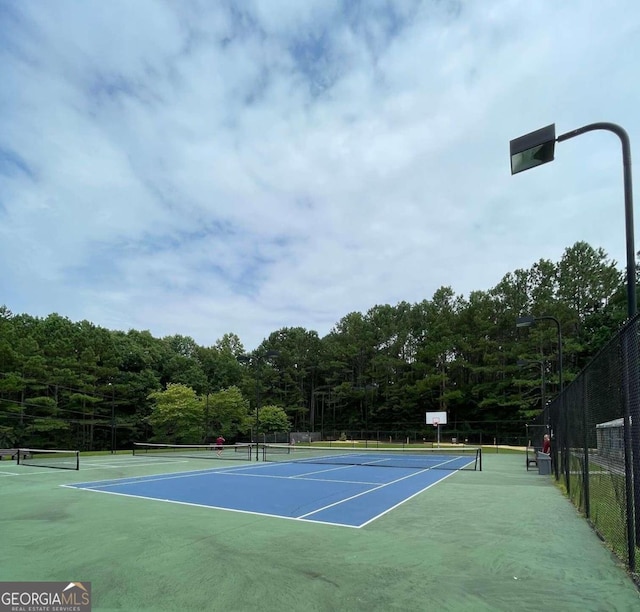 view of sport court featuring fence