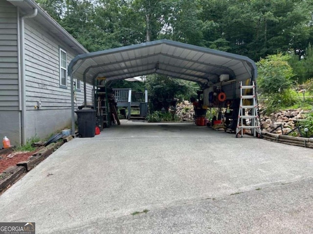 view of vehicle parking with concrete driveway and a detached carport