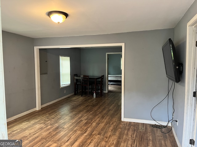 interior space with electric panel and dark wood-type flooring