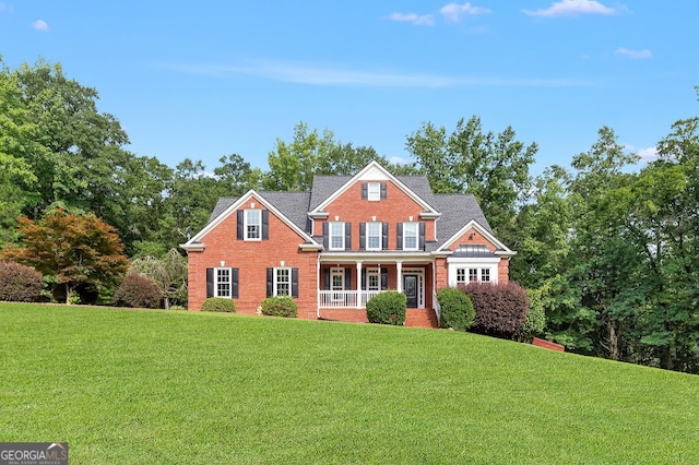 view of front of home featuring a porch and a front lawn