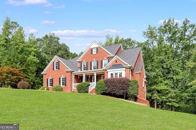 view of front facade with covered porch and a front yard