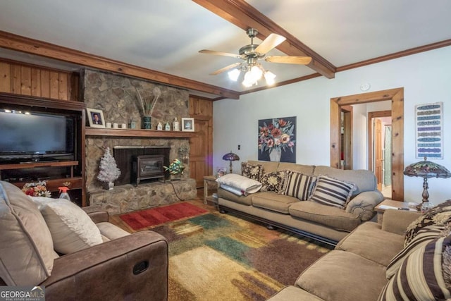 living room with a fireplace, beamed ceiling, wooden walls, and ceiling fan