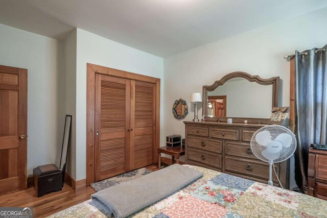 bedroom with a closet and light wood-type flooring