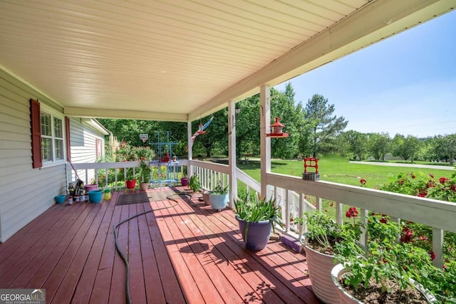 wooden deck with a lawn