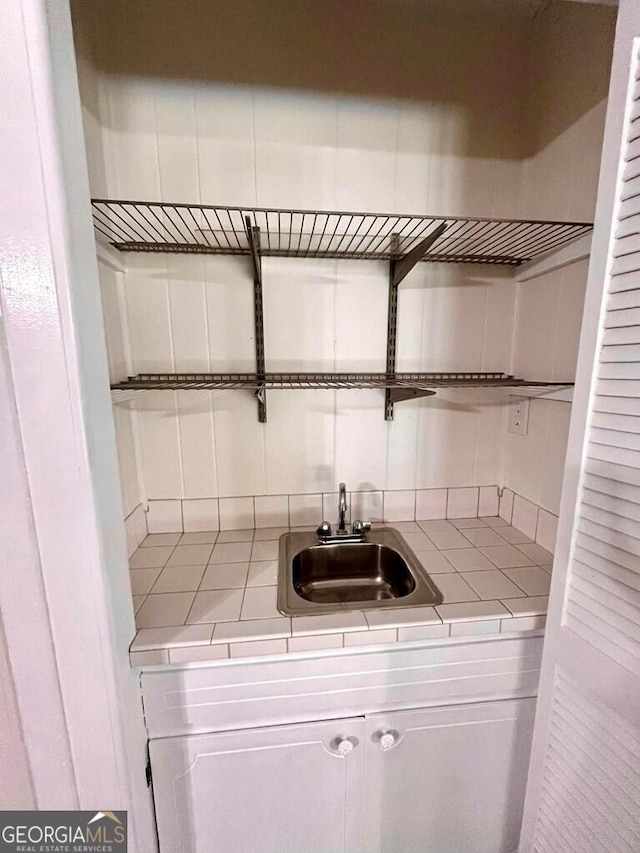 interior space featuring sink and white cabinets