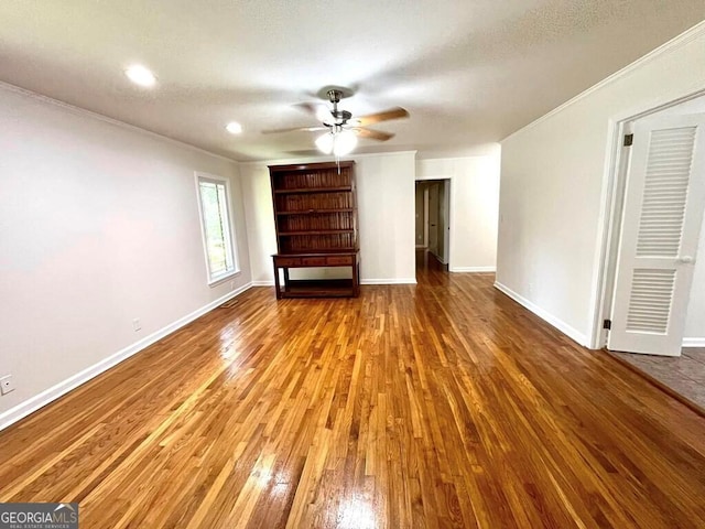 unfurnished living room with crown molding, ceiling fan, and hardwood / wood-style floors