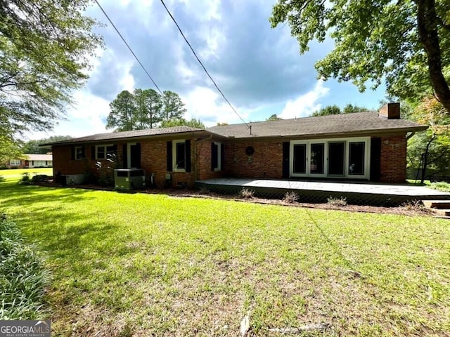 rear view of house featuring a yard and a patio area