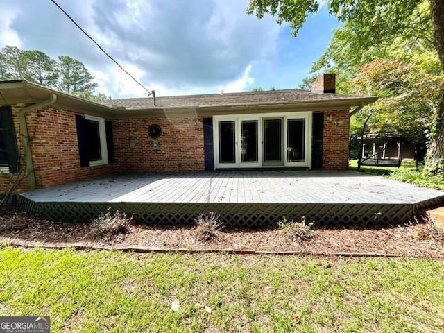 back of house with a yard and a deck