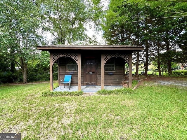 view of outbuilding with a yard