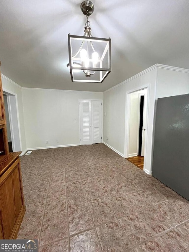 interior space with ornamental molding and a chandelier