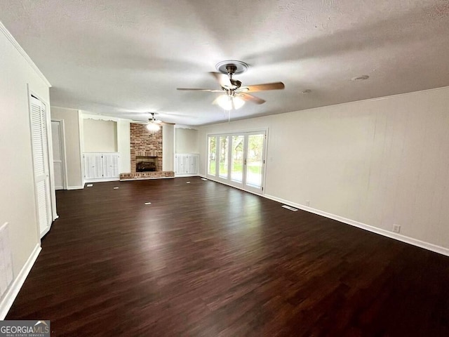 unfurnished living room with ceiling fan, a fireplace, and dark hardwood / wood-style flooring