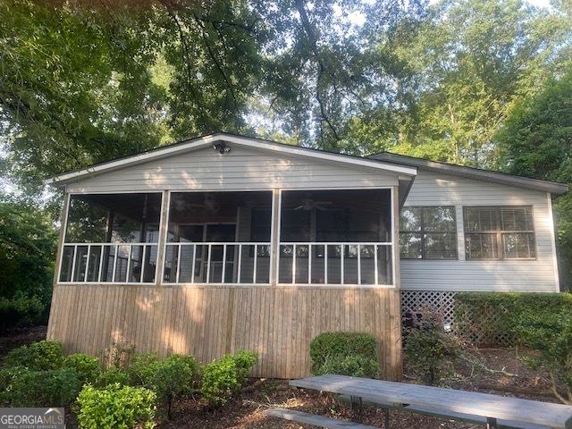 view of front of home featuring a sunroom