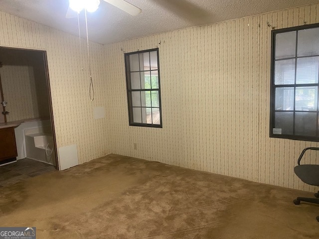 unfurnished bedroom featuring carpet floors, a textured ceiling, and ceiling fan