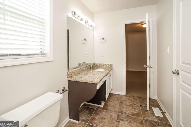 bathroom with vanity, toilet, and tile patterned floors