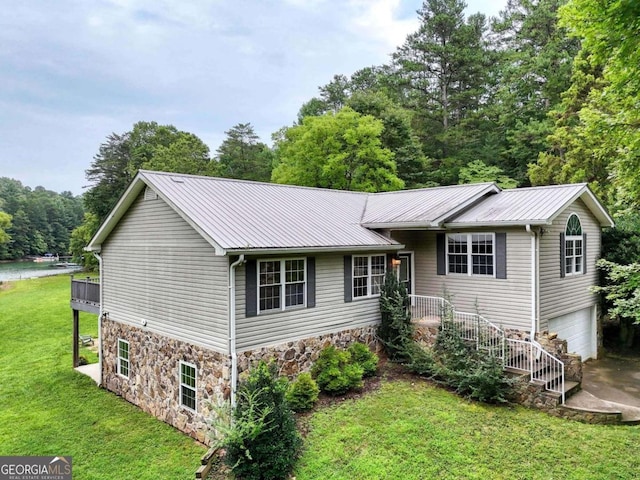 view of front of home with a garage and a front lawn