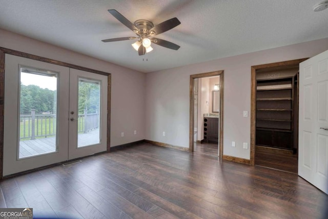 unfurnished bedroom with dark hardwood / wood-style floors, access to exterior, ceiling fan, a textured ceiling, and french doors