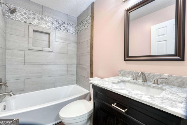 full bathroom with tiled shower / bath, vanity, toilet, and a textured ceiling