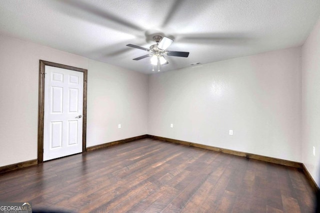 spare room with ceiling fan, dark hardwood / wood-style flooring, and a textured ceiling