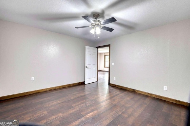 unfurnished room featuring ceiling fan and dark hardwood / wood-style flooring