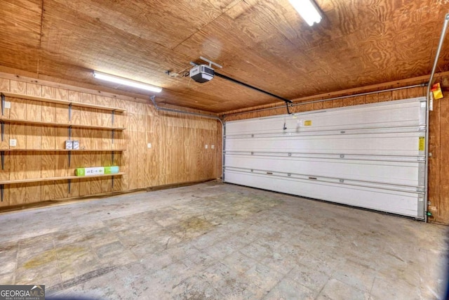 garage featuring a garage door opener, wooden ceiling, and wood walls