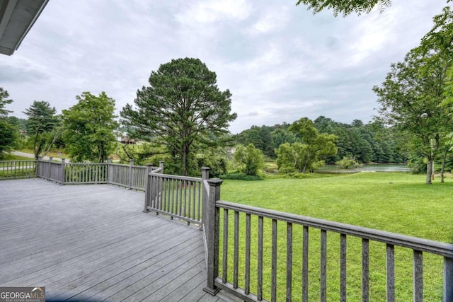 wooden deck featuring a lawn