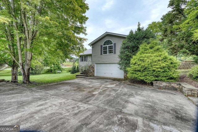 view of home's exterior featuring a yard and a garage