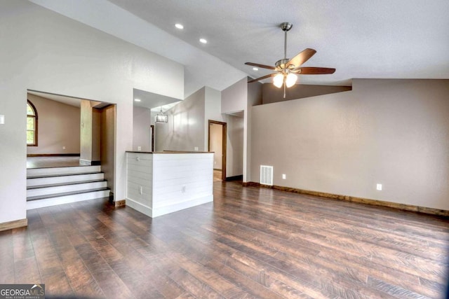 unfurnished living room featuring dark wood-type flooring, ceiling fan, and high vaulted ceiling