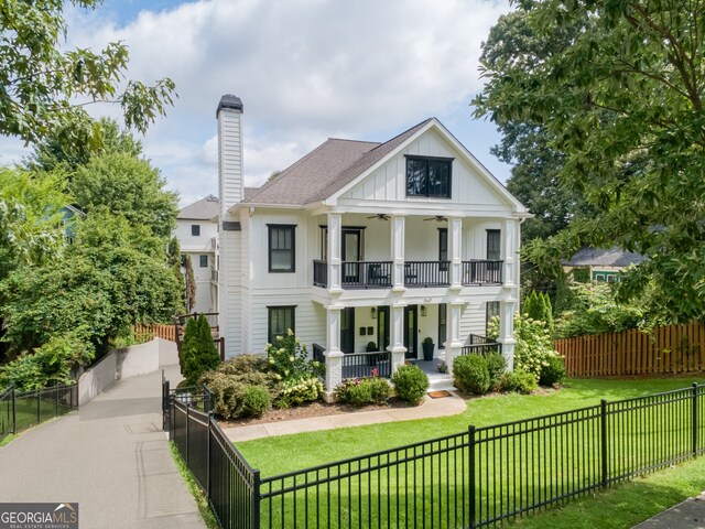 view of front facade featuring covered porch, a balcony, and a front lawn