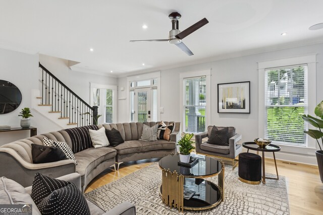 living room with plenty of natural light, crown molding, ceiling fan, and light hardwood / wood-style floors