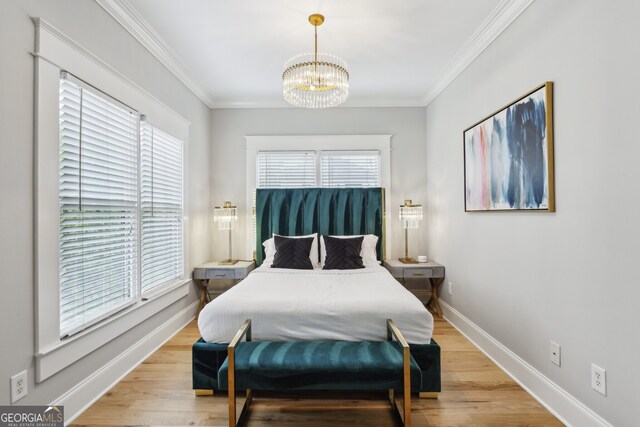 bedroom featuring multiple windows, ornamental molding, and light hardwood / wood-style floors