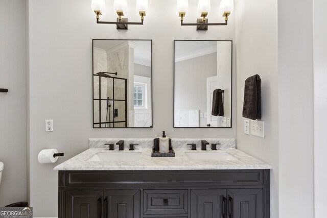 bathroom featuring double sink vanity, crown molding, and toilet