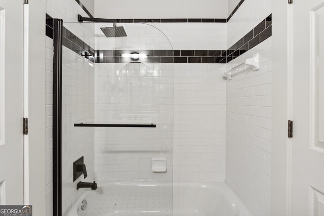 bathroom featuring shower / bath combination with glass door