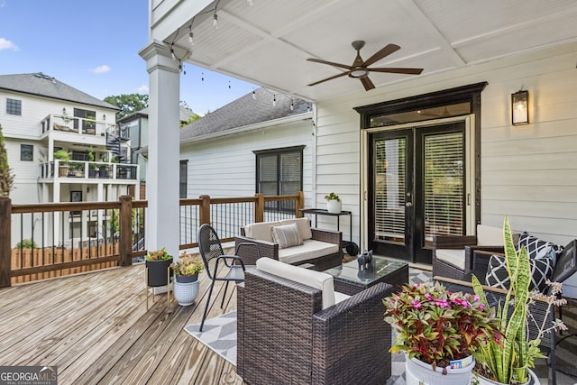 wooden terrace featuring an outdoor living space and ceiling fan