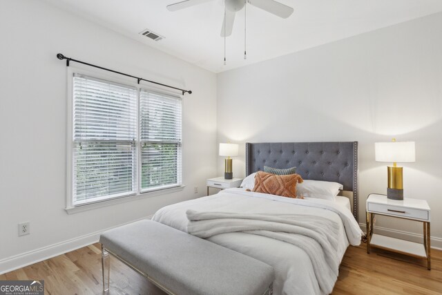 bedroom with light hardwood / wood-style floors and ceiling fan