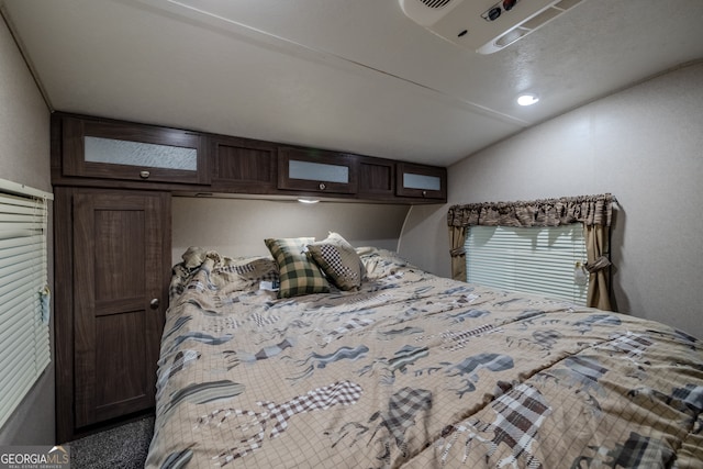 bedroom with carpet flooring and vaulted ceiling