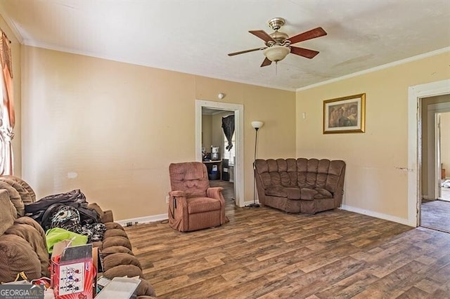 living room with ornamental molding, ceiling fan, and hardwood / wood-style floors