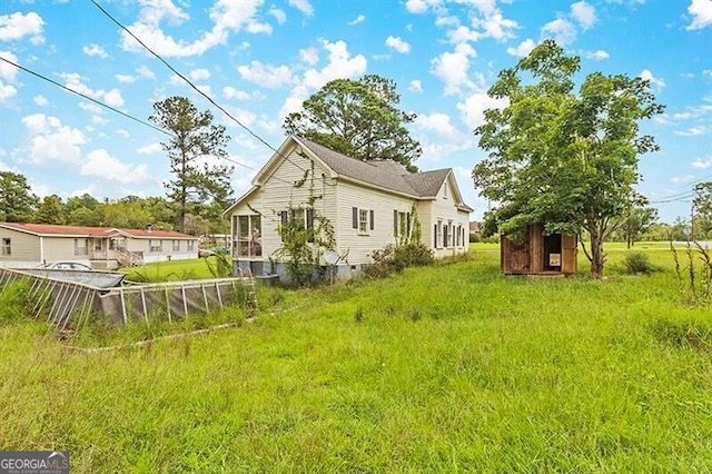 view of home's exterior with a storage shed