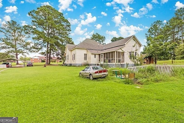 rear view of house featuring a lawn