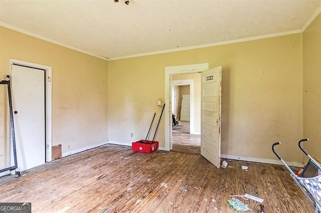 unfurnished bedroom featuring wood-type flooring and ornamental molding