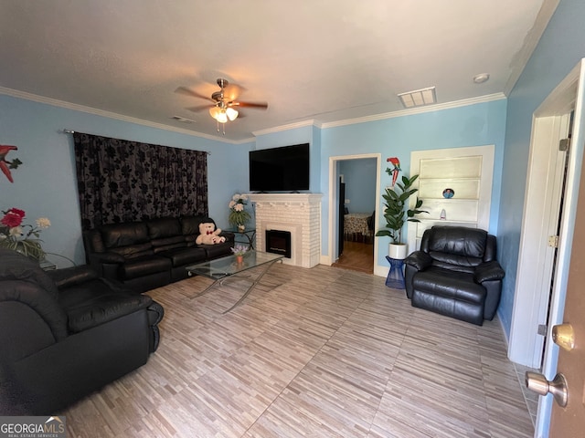 living room with ornamental molding, a fireplace, and ceiling fan