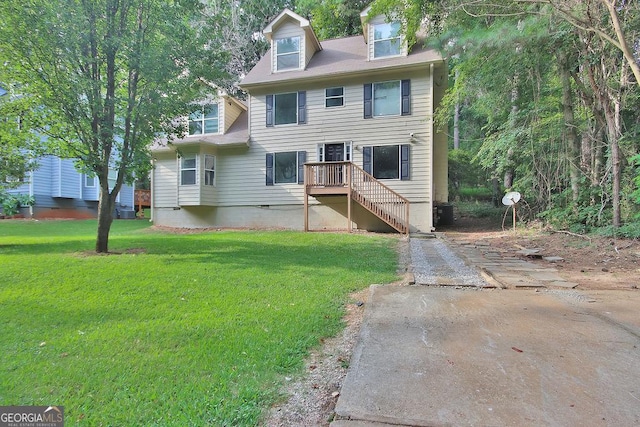 rear view of house featuring a yard