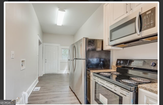 kitchen with white cabinetry, light hardwood / wood-style flooring, and appliances with stainless steel finishes