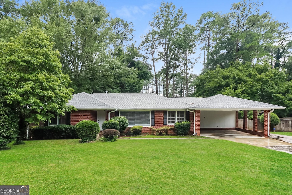 ranch-style house with a carport and a front yard